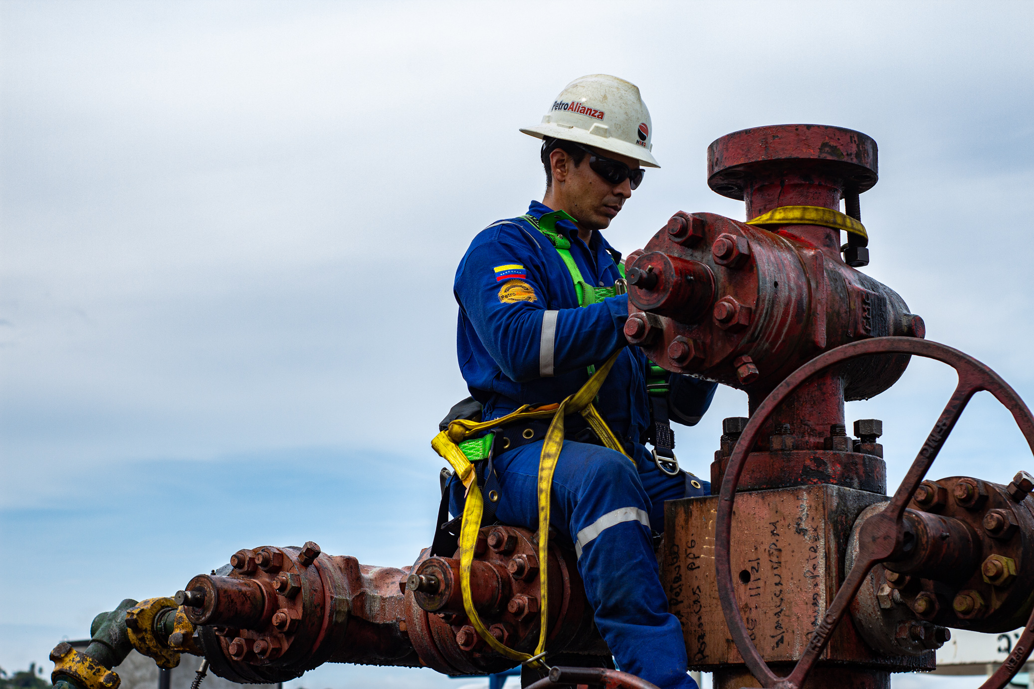 PetroAlianza specialist working on wellhead equipment